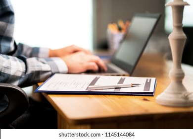 Survey Form, Customer Satisfaction Feedback Poll, Resume For Job Application Or For College. Man Writing With Laptop.  Home Or Car Insurance Contract. Paper Sheet And Pen On Desk.