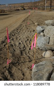 Survey Stakes Are Used To Mark Lines And Grades On A Road Construction Project