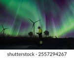 Survey Team Alternative energy for future at night for inspector safety.  Engineers survey and checking wind turbines at aurora light background. Wind Turbine Renewable energy technology