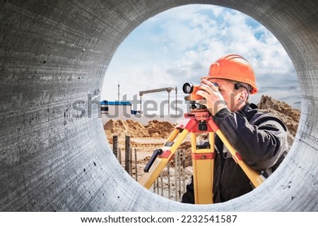 Surveyor engineer is measuring level on construction site. Surveyors ensure precise measurements before undertaking large construction projects. Design work in construction. Close-up