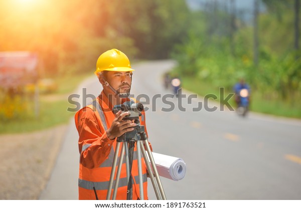 Surveyor\
engineer worker making measuring with theodolite on road\
works.survey engineer in construction\
site.