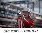 Surveyor engineers team wearing safety uniform and blueprint checking inspection by theodolite telescope to measurement level position railway construction site is industry transportation concept.