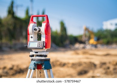 Surveyor equipment tacheometer or theodolite outdoors at construction site for civil engineer checking the construction area.