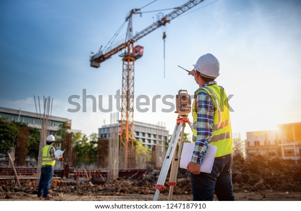 Surveyor\
equipment. Surveyor’s telescope at construction site or Surveying\
for making contour plans is a graphical representation of the lay\
of the land startup construction\
work.
