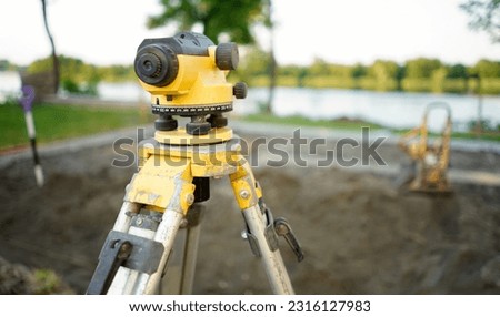 Surveyor equipment theodolite on the construction site. Land surveying with optical measurement tools. Theodolite on the site. Measurement on construction site.