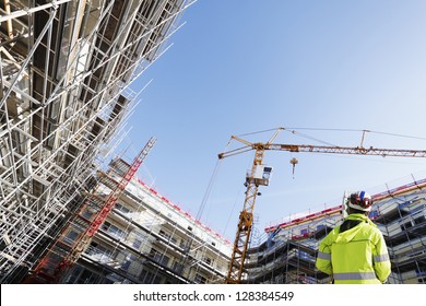 surveyor with instrument, surveying large building-site, super-.wide perspective