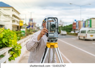 A surveyor at work with an infrared reflector used for distance measurement on roadside
A land surveying professional is called a land surveyor.