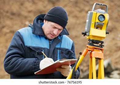 Surveyor Worker Make Data Collection With Total Station Theodolite At Construction Site