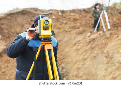 Surveyor Worker Make Data Collection With Total Station Theodolite At Construction Site