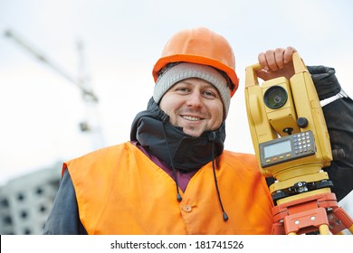 Surveyor Worker Portrait With Theodolite Transit Equipment At Road Construction Site Outdoors