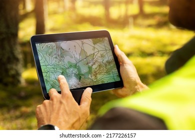 surveyor working with forest topography map in digital tablet. land surveying - Shutterstock ID 2177226157