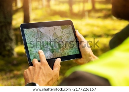 surveyor working with forest topography map in digital tablet. land surveying