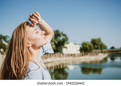 Survive Summer In The City, Surviving The Heat, Summer Outfit, Wear Breathable Fabrics. Young Blond Woman In Blue Linen Dress On City Street