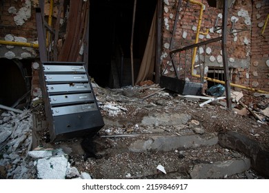 A Surviving Metal Mailbox In A Brick Building That Burned To The Ground. A Destroyed House In Irpen After A Missile Hit. Devastation In Ukrainian Cities From An Attack By Russian Forces.