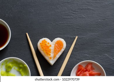Sushi abstract seafood heart concept on black marble menu background
