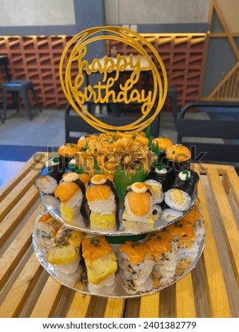 sushi cake filled with various types of sushi. There are 2 stacks of sushi that you can enjoy. With 