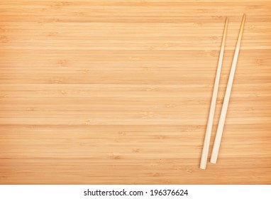 Sushi chopsticks on bamboo table with copy space