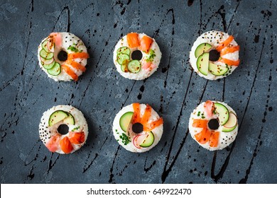Sushi donuts set on black background. Sushi trend. Creative food. Flat lay, top view