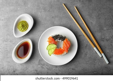 Sushi doughnut on grey textured background