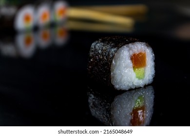 Sushi With Fish On A Glossy Black Surface