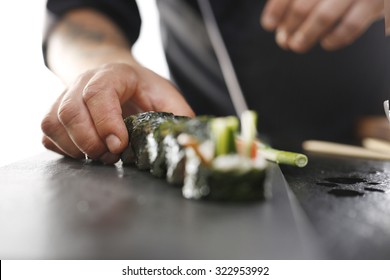 Sushi master preparing sushi in Japanese restaurant 