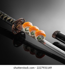 Sushi on a Japanese Katana with reflection on a black background. Poster sushi bar menu photo concept