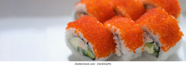 Sushi With Orange Flying Fish Caviar On A White Plate