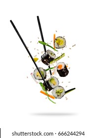 Sushi pieces placed between chopsticks, separated on white background. Popular sushi food.