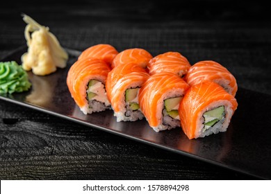 Sushi roll (Philadelphia) with salmon, smoked eel, avocado, cream cheese on black background. Sushi menu. Japanese food. - Shutterstock ID 1578894298