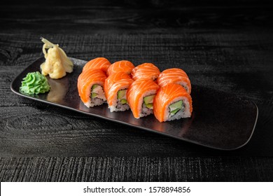 Sushi roll (Philadelphia) with salmon, smoked eel, avocado, cream cheese on black background. Sushi menu. Japanese food. - Powered by Shutterstock