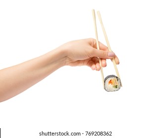 Sushi roll with wooden chopsticks in female hand on white background 