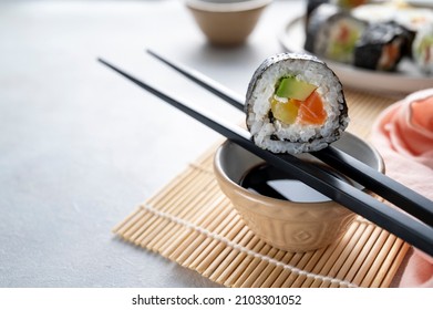 Sushi rolls close up with salmon, avocado and cucumber - Powered by Shutterstock