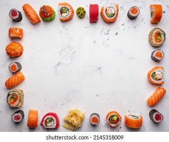 Sushi and rolls. Frame with Japanese food on a white background. Top view, copy space.