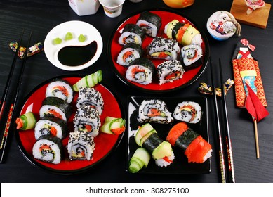 sushi rolls set for japanese style party on black table