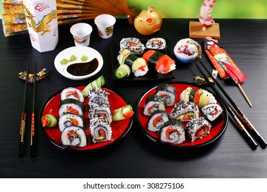 sushi rolls set for japanese style party on black table