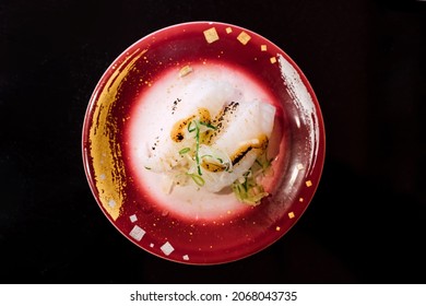 Sushi and Sashimi. Dishes of Sushi and Sashimi rolling on conveyer belt. - Shutterstock ID 2068043735