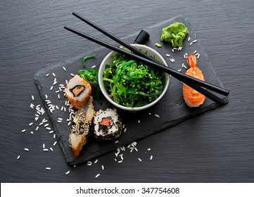 Sushi And Seaweed Salad On Slate Table