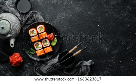 Sushi set with caviar, avocado and salmon. Asian cuisine. Top view. Free space for your text.