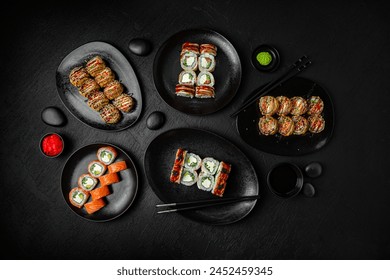 Sushi set composition on black background. The Art of Japanese Cuisine. Food photography for menu and sushi bar decoration - Powered by Shutterstock