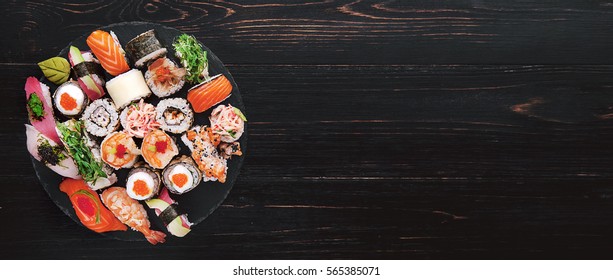 Sushi set on a black wooden background