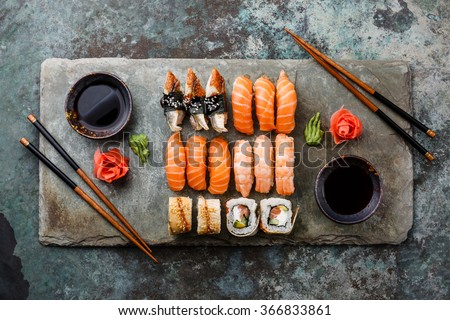 Sushi Set sashimi and sushi rolls served on stone slate Stockfoto © 