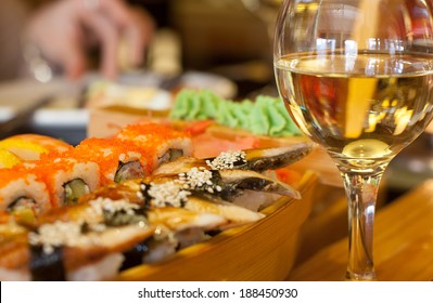 Sushi and white wine on the table
