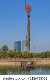 Suspended In Air Crane Hoist Basket Over River Water