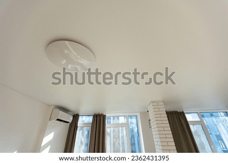 suspended ceiling with halogen spots lamps and drywall construction in empty room in apartment or house. Stretch ceiling white