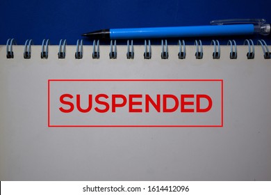 Suspended write on a book isolated on blue background.