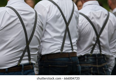 groomsmen in jeans and suspenders