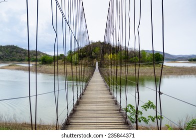 Suspension bridge above the lake, path way to forest. Kaeng Krachan national park, Phetchaburi, Thailand.