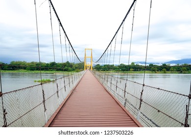 Suspension Bridge across the Ping River in Tak Province, Thailand.                               