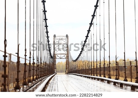 suspension bridge across the river, altai view dilapidated old bridge crossing
