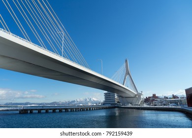 The Suspension Bridge Cross The Bay Of Aomori City Which Has The Snow Mountain In Background, Aomori Prefecture, Japan 
